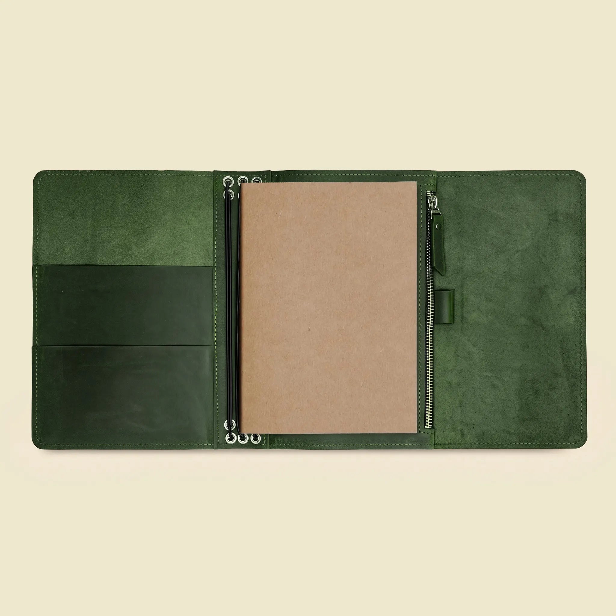 Handmade leather journal cover with adaptable storage for notebooks and sketching supplies.