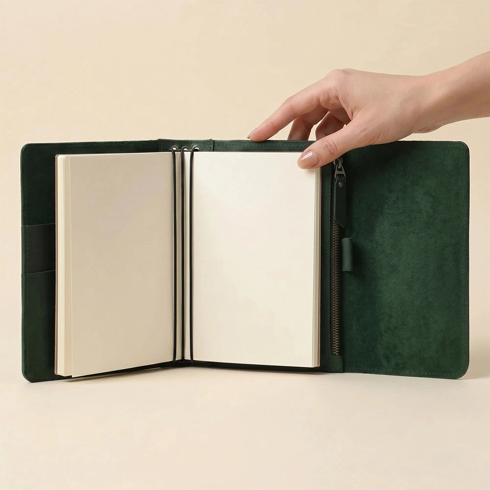 Leather journal organizer with pen loop and multiple elastic inserts.