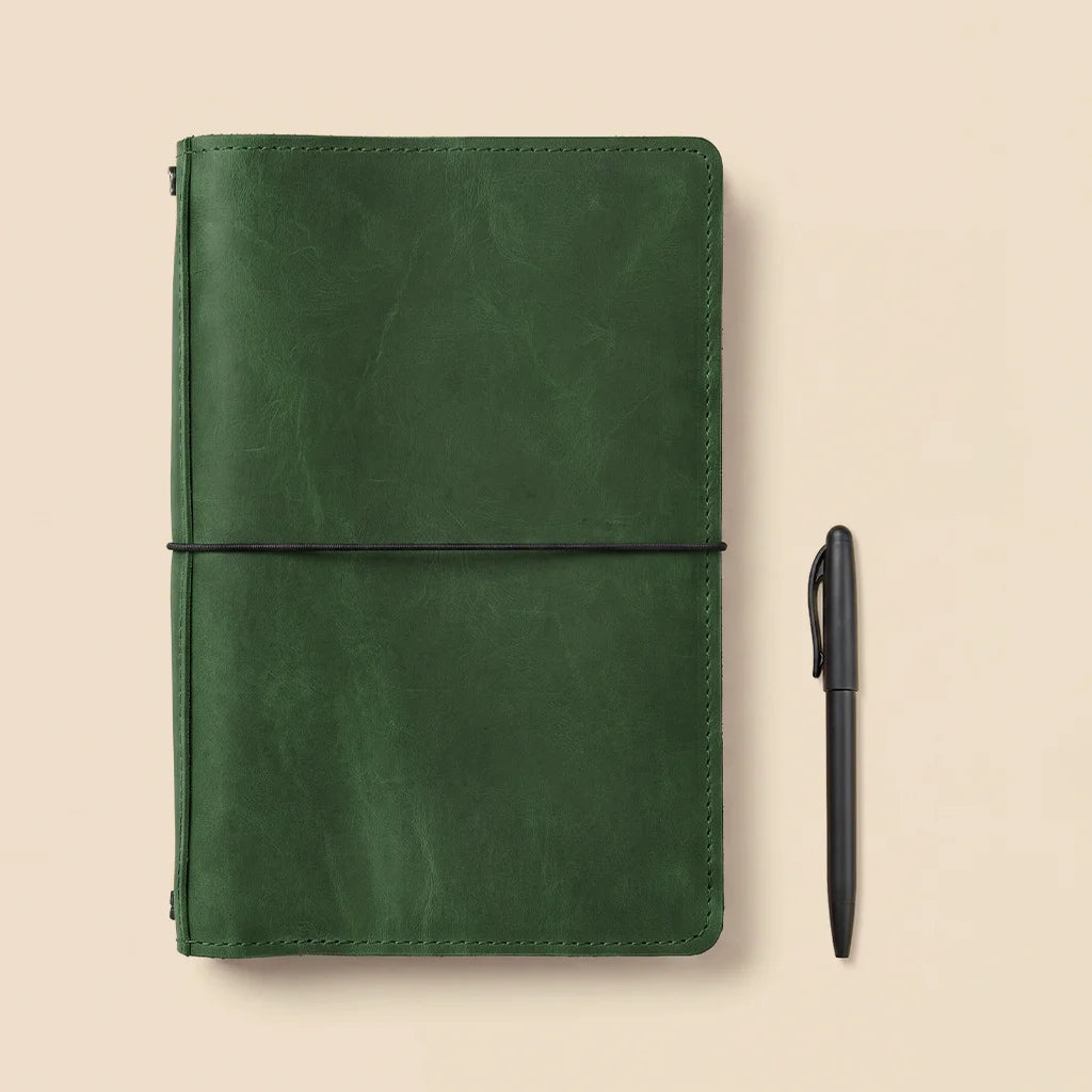 Handmade leather planner cover with spacious organizer layout and refillable elastic notebook holders.