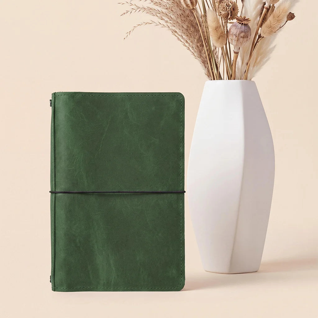 Genuine leather notebook cover featuring flexible elastic holders for multiple notebook inserts.