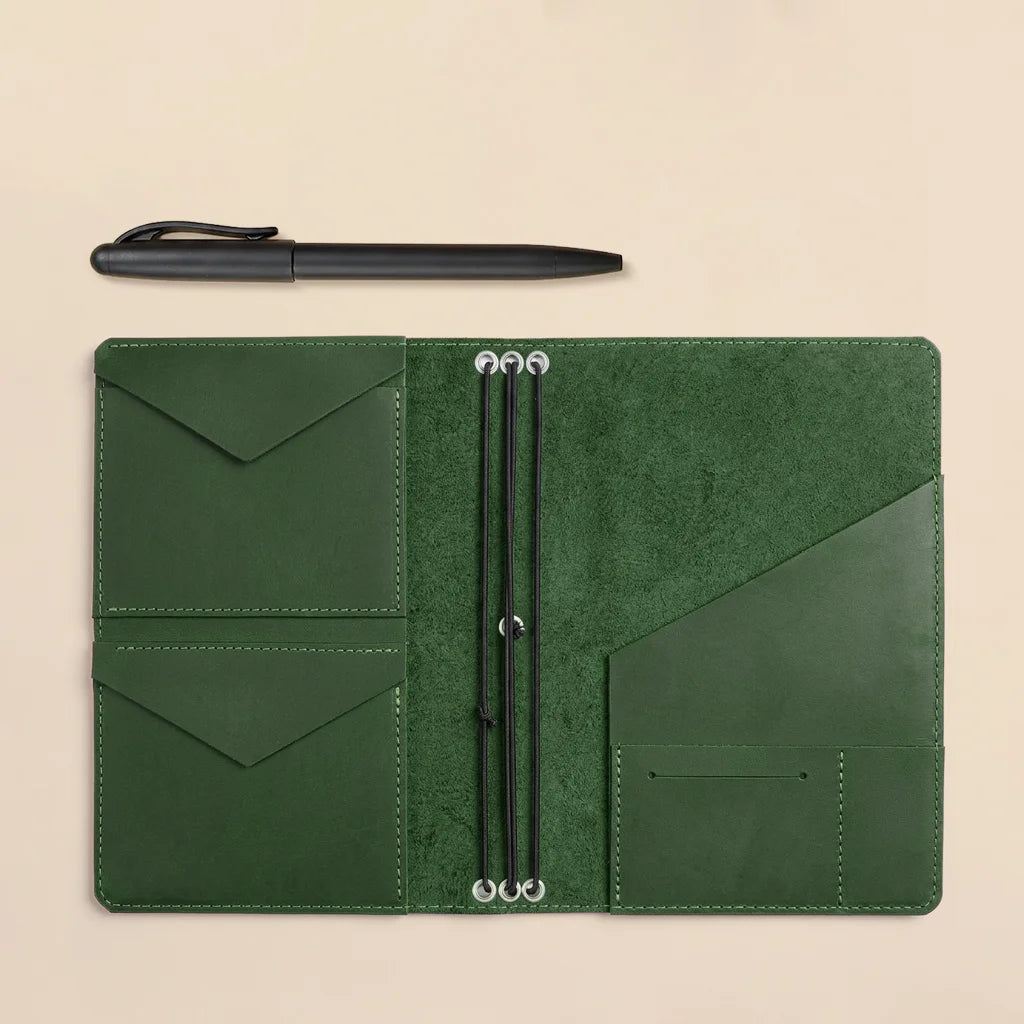 Genuine leather notebook cover with interior pockets and elastic bands for journal organization.