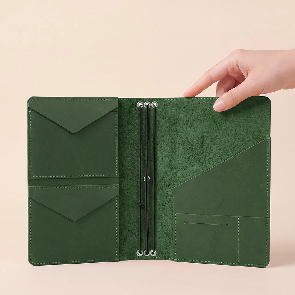 Premium leather notebook cover with multiple interior pockets and secure elastic notebook holders.