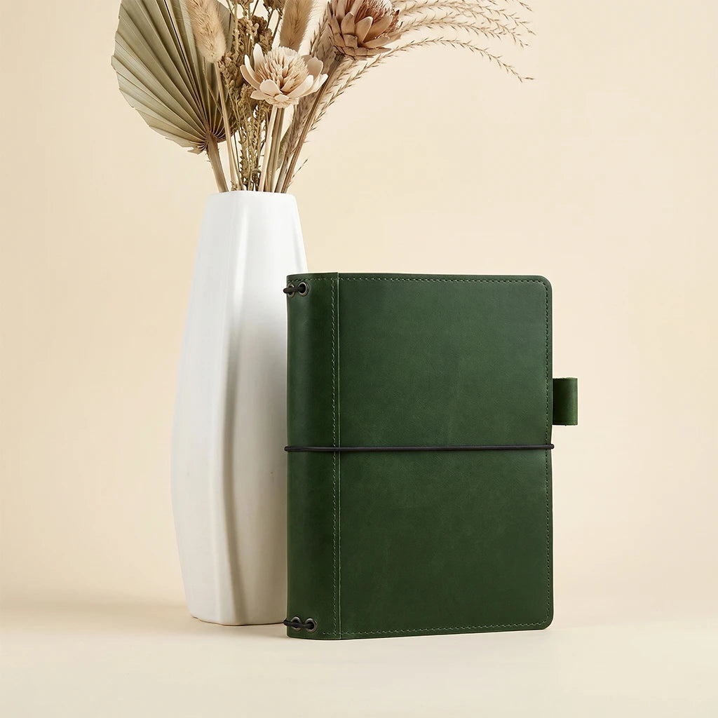 Handmade leather notebook cover with interior storage and elastic notebook holders