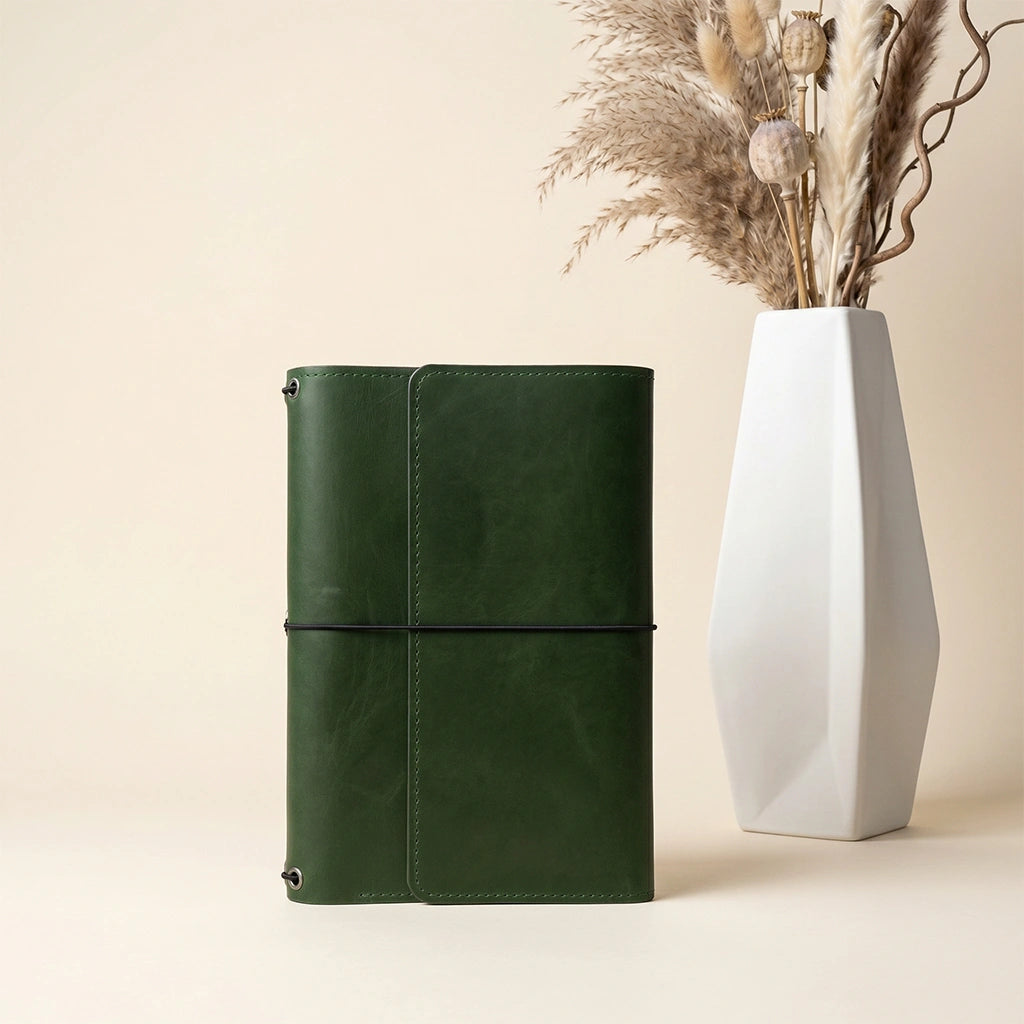 Refillable leather writing organizer with flexible elastic bands for multiple notebook inserts.