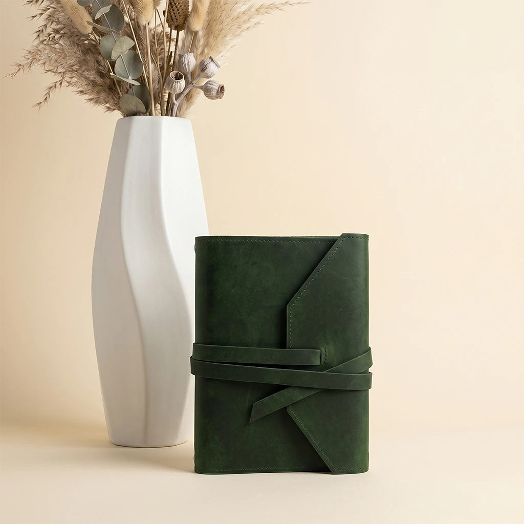 Leather notebook cover with functional design for journaling and note-taking.