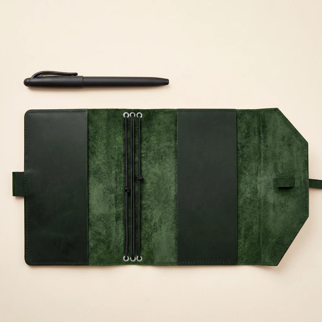 Classic leather notebook case with secure elastics and practical pen holder feature.