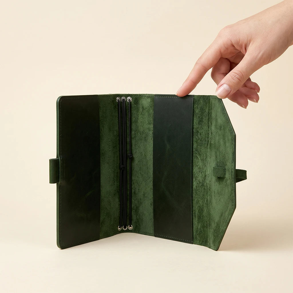Functional leather notebook cover with elastic closure and attached pen holder.