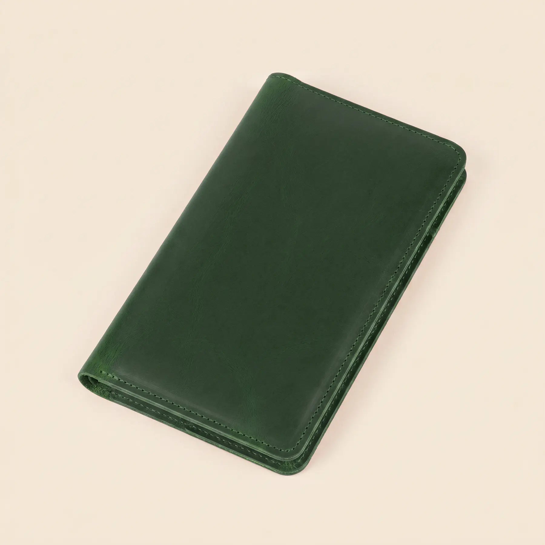 Premium long leather wallet with secure button closure, card slots, and zippered interior organization.