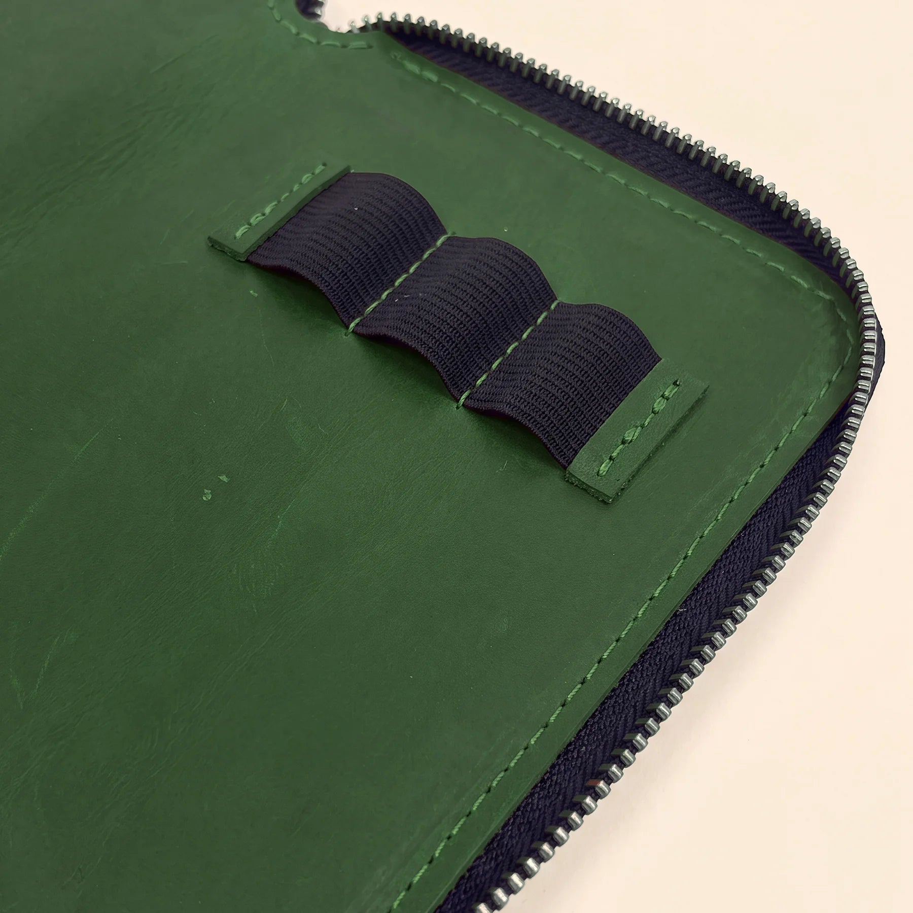 Leather pen pouch handcrafted with zipper and spacious interior for writing essentials.
