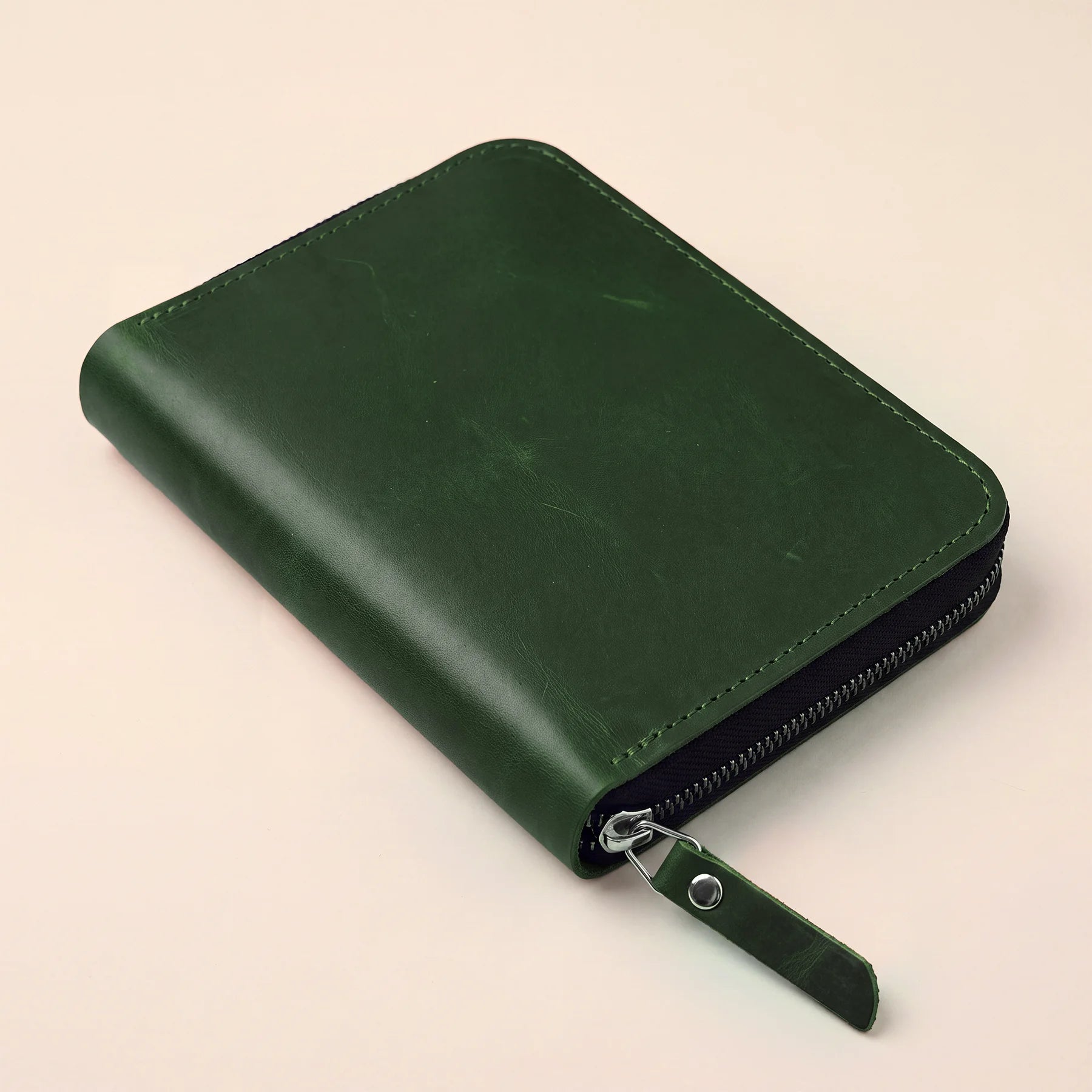 Natural leather pen storage bag with secure zip and refined handmade craftsmanship.