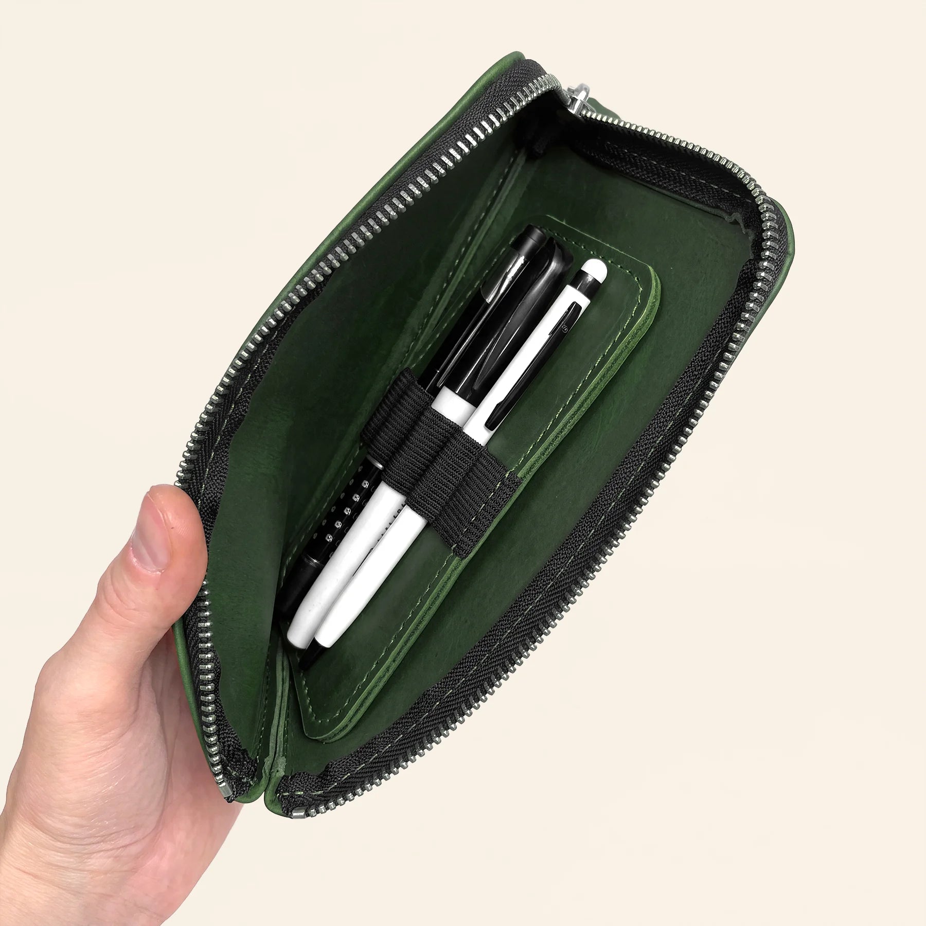 Natural leather office pouch with zipper keeps writing accessories safely organized.
