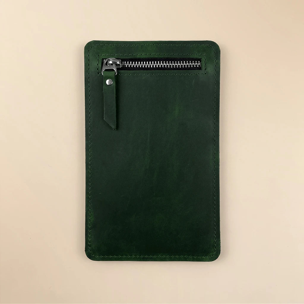 Minimalist leather pocket insert attached to notebook with elastic band