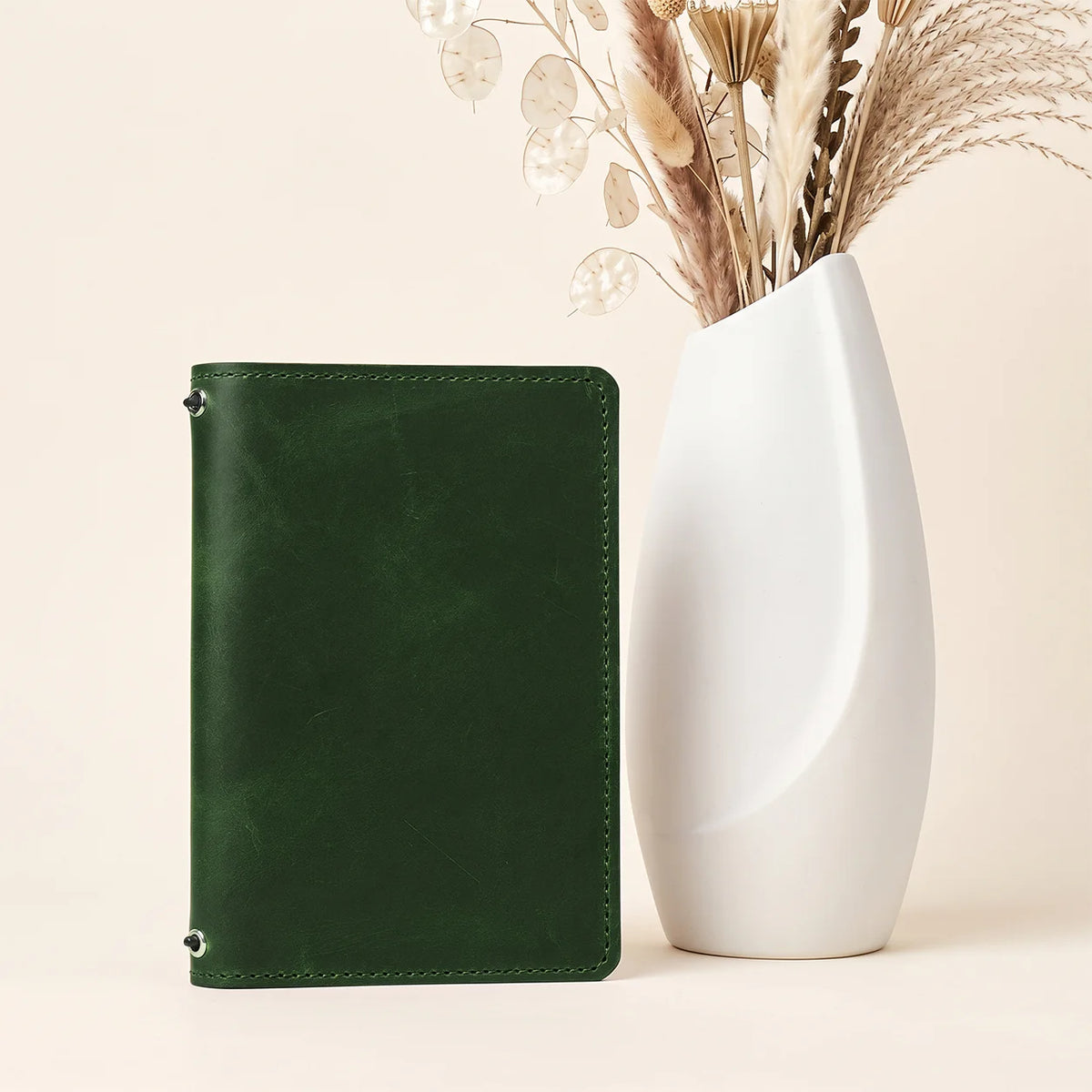 Handmade leather journal cover with two elastic bands and convenient storage compartments