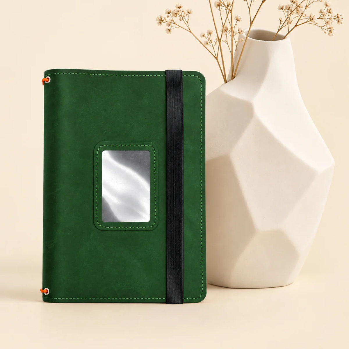 Handmade leather notebook case with three secure elastic straps and organized storage sections.