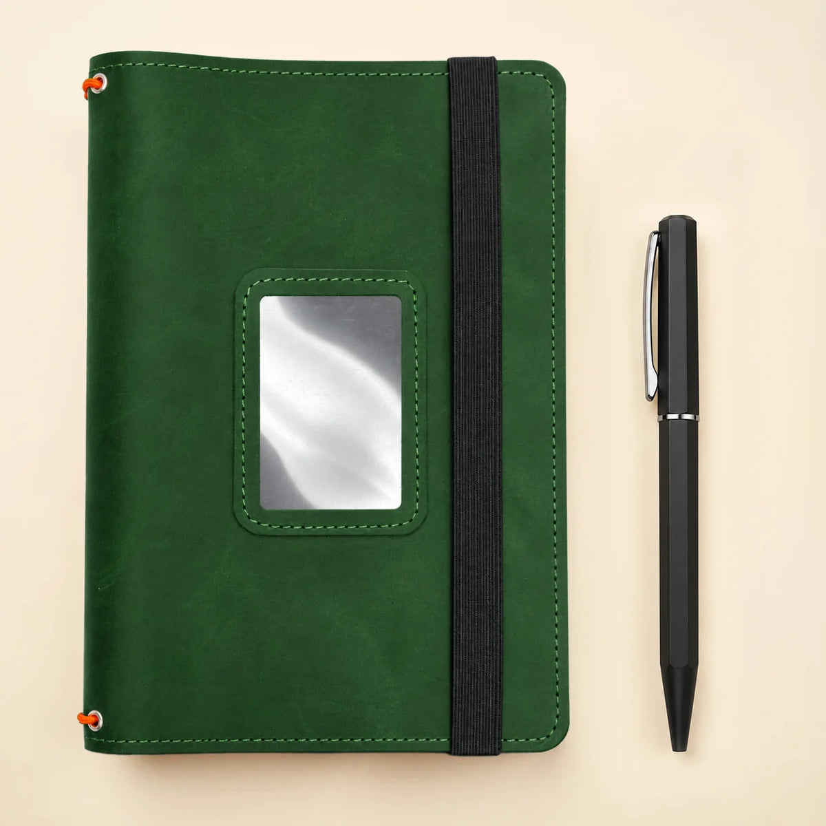 Genuine leather notebook cover with three elastic bands and dedicated spaces for personal accessories.