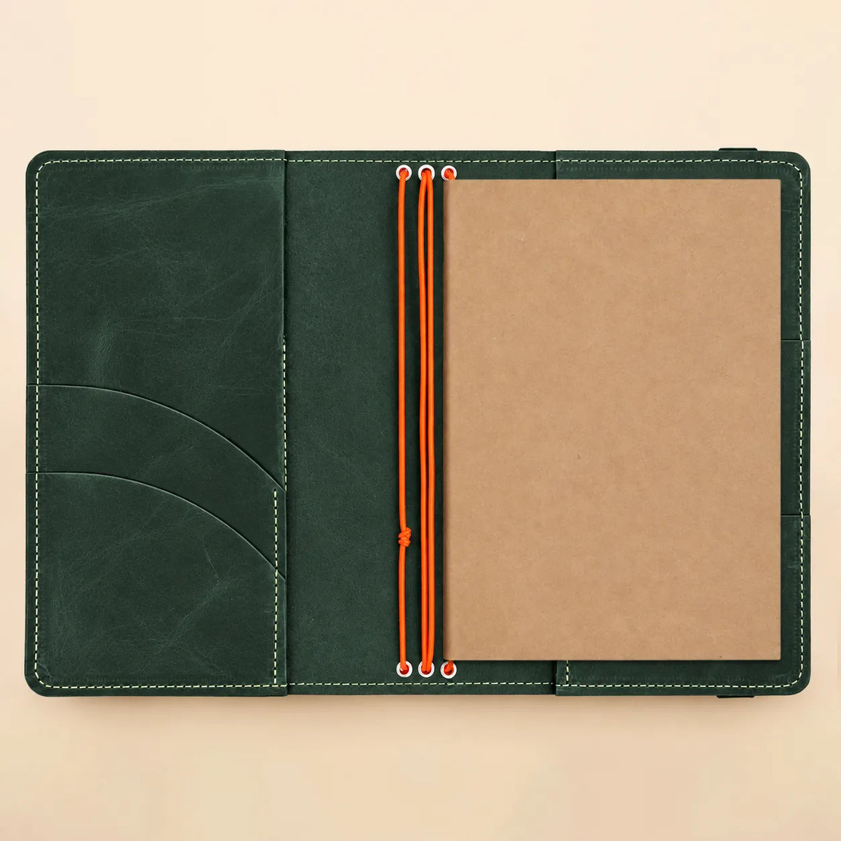 Handmade leather notebook cover with three elastic loops, internal pockets, and clear photo viewing panel.