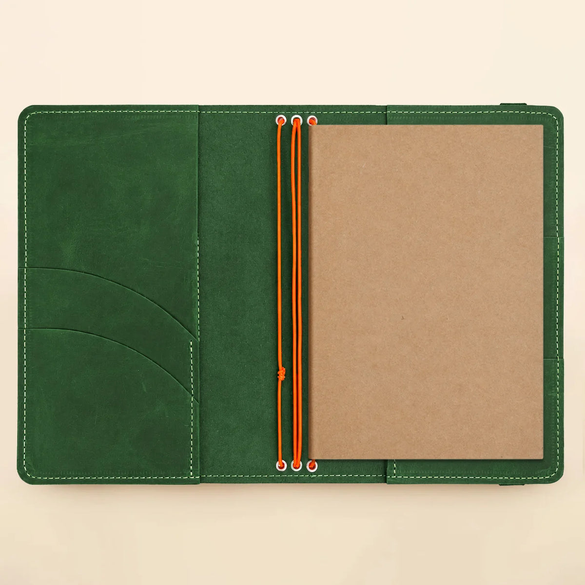 Natural leather journal organizer with three secure straps and spacious pockets for accessories.