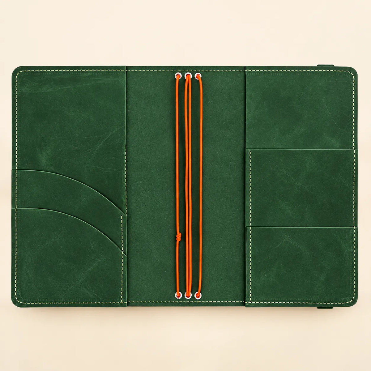 Natural leather journal case with three elastic notebook holders and carefully arranged inner pockets.