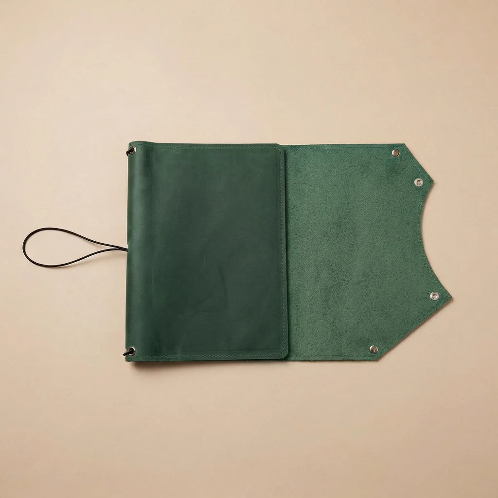 Green leather pouch with a strap on a beige background