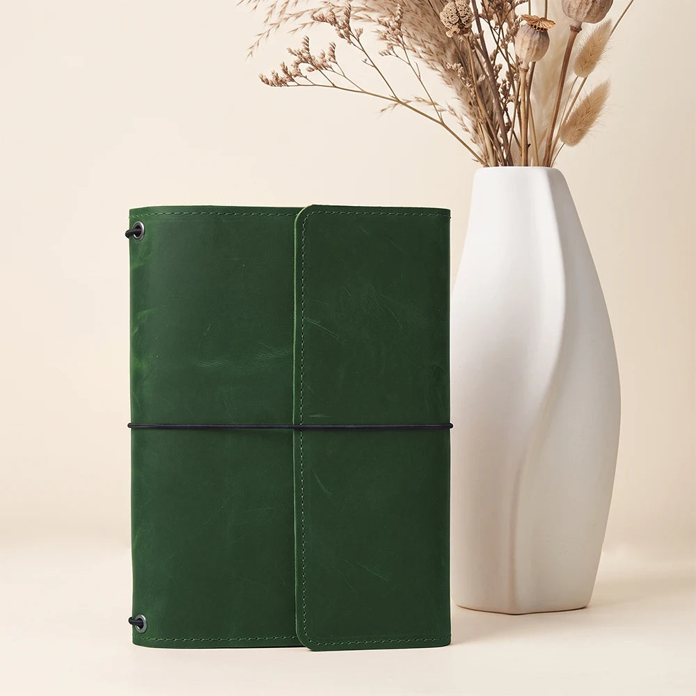 Genuine leather notebook cover offering organized storage and flexible refillable insert compatibility.