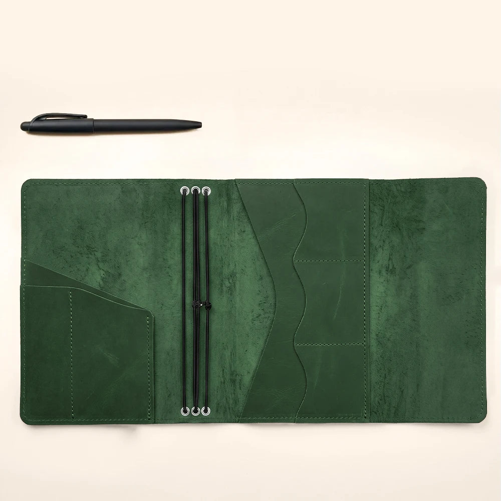 Leather planner sleeve with refillable insert capability and convenient pen holder inside.
