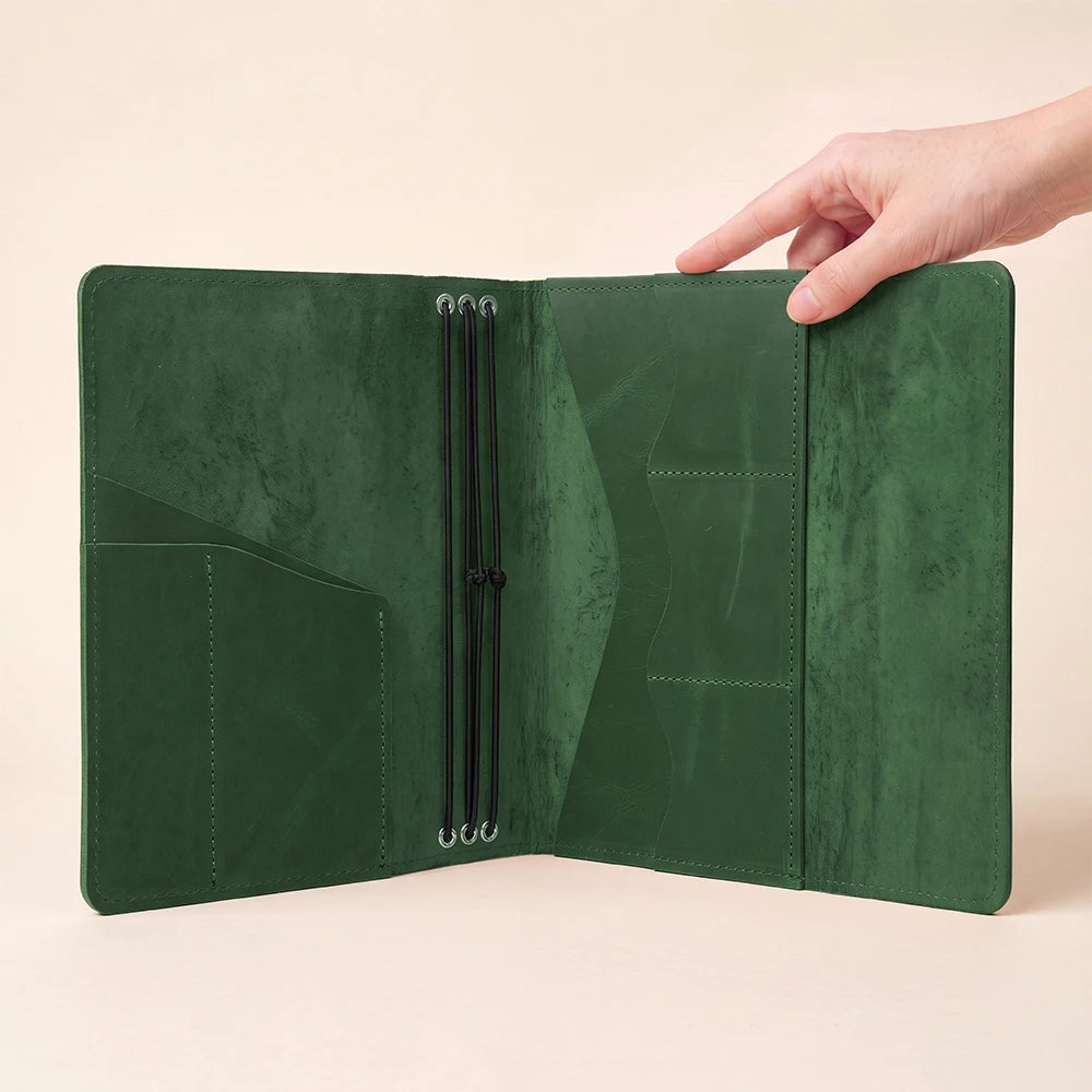 Genuine leather refillable notebook cover with organized pockets for cards and small accessories.