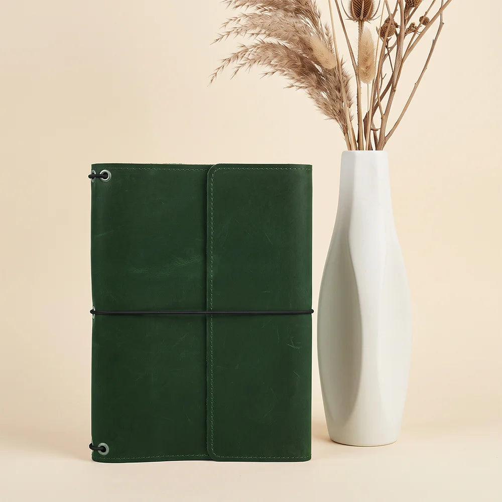 Handcrafted leather journal cover with three elastic bands and functional interior organizer pockets.