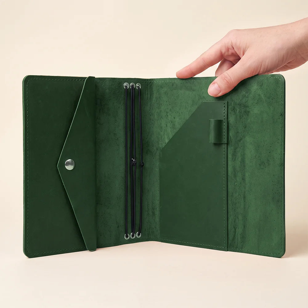 Durable leather notebook organizer designed with flexible elastics and interior accessory compartments.