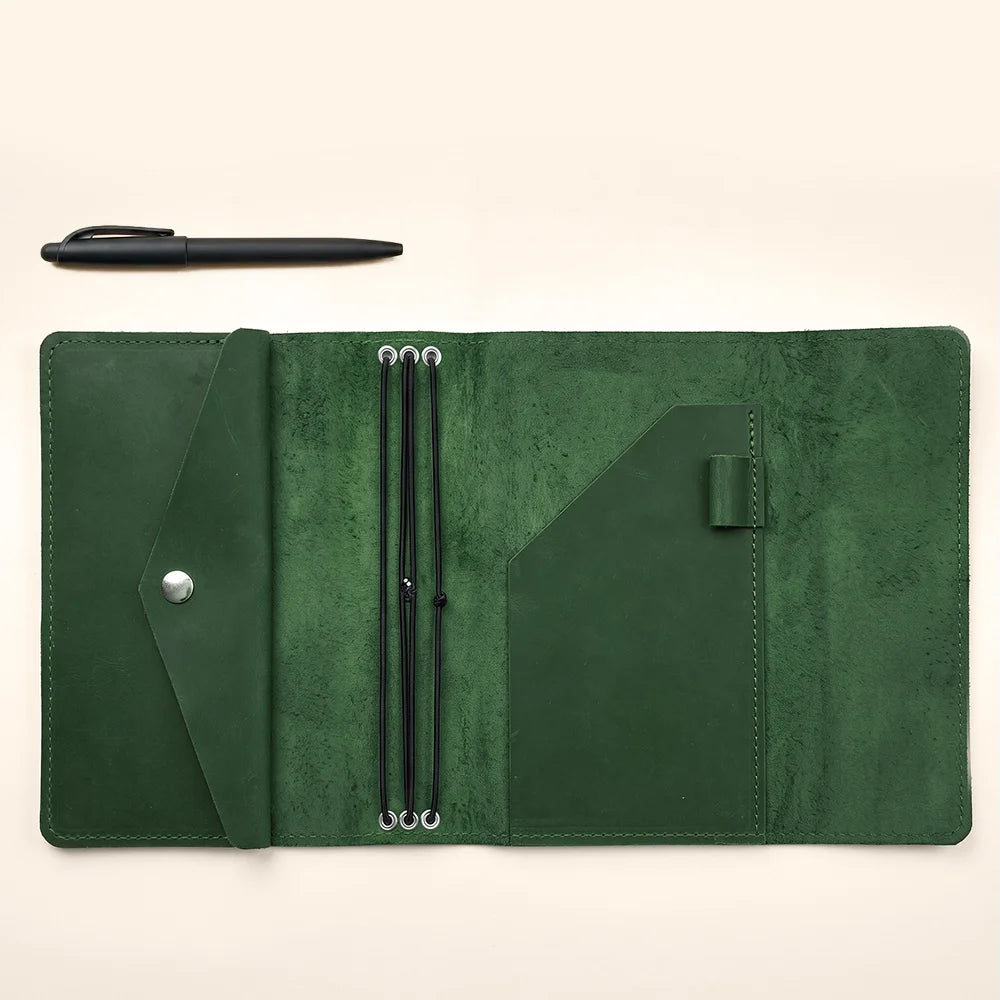 Refillable journal organizer made from genuine leather with secure elastic notebook retention system.