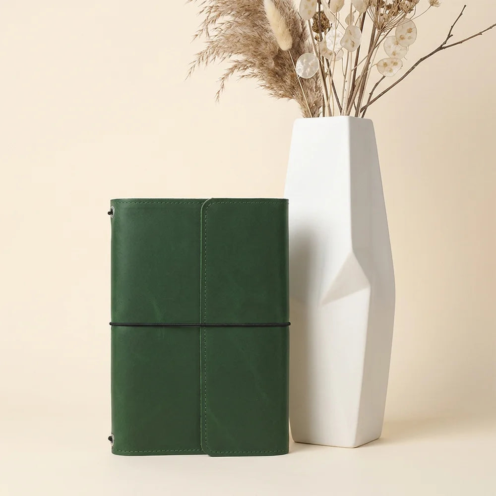 Genuine leather notebook organizer displaying thoughtfully arranged interior compartments and convenient pen carrying space.