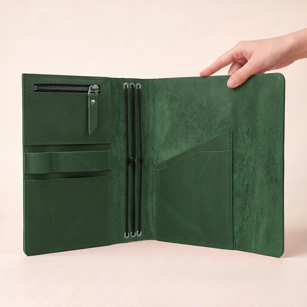 Natural leather planner cover with durable stitching, functional pockets, and dedicated writing tool storage.