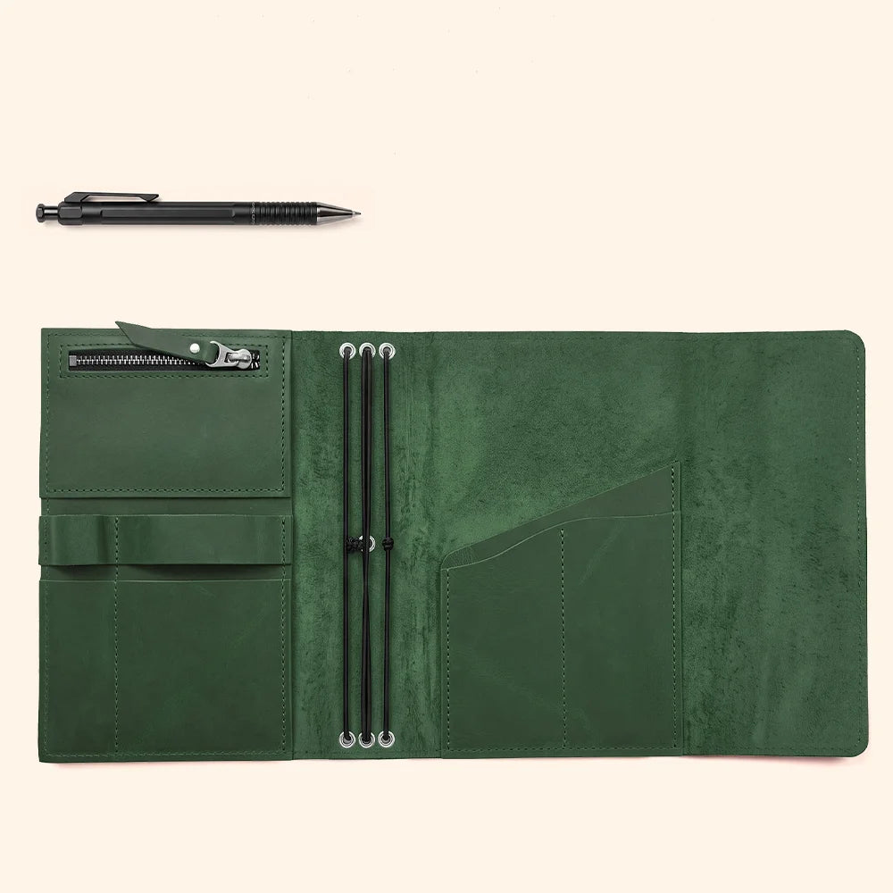 Genuine leather notebook sleeve showing detailed stitching, interior pockets, and a secure pen loop.