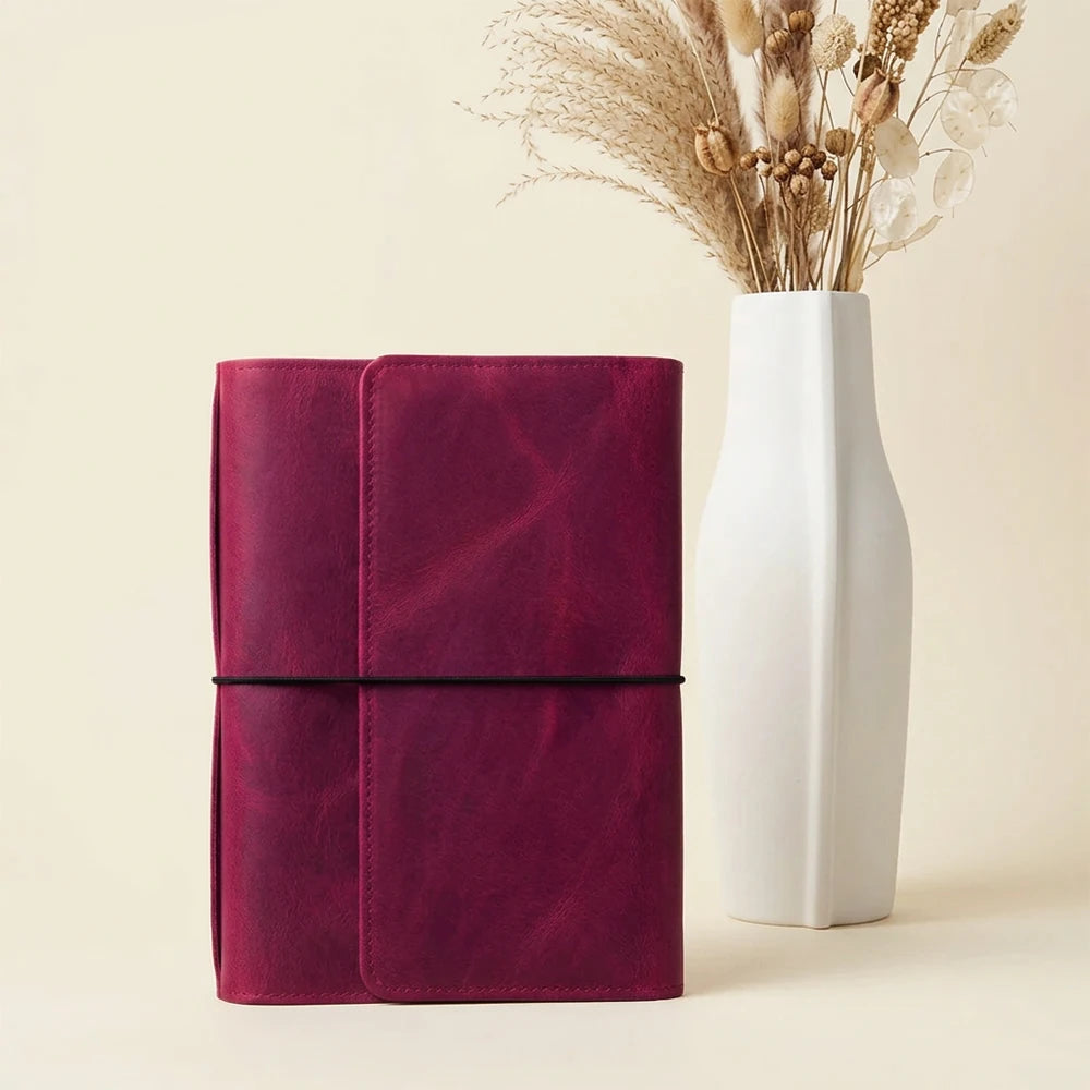 Genuine leather planner organizer featuring six elastic bands and useful interior compartments.