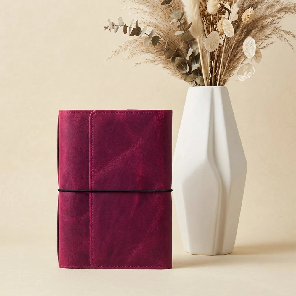 Handmade leather journal cover with six elastic bands and secure interior storage.