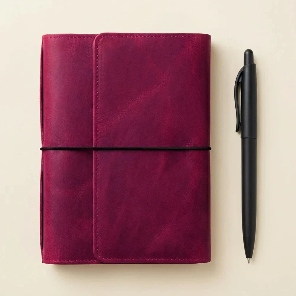 Leather notebook cover featuring six elastic bands for holding multiple notebooks securely.