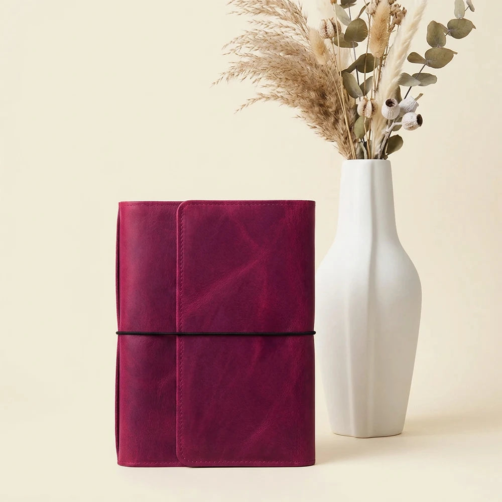 Handmade leather notebook cover featuring six elastic closures and practical storage pockets.