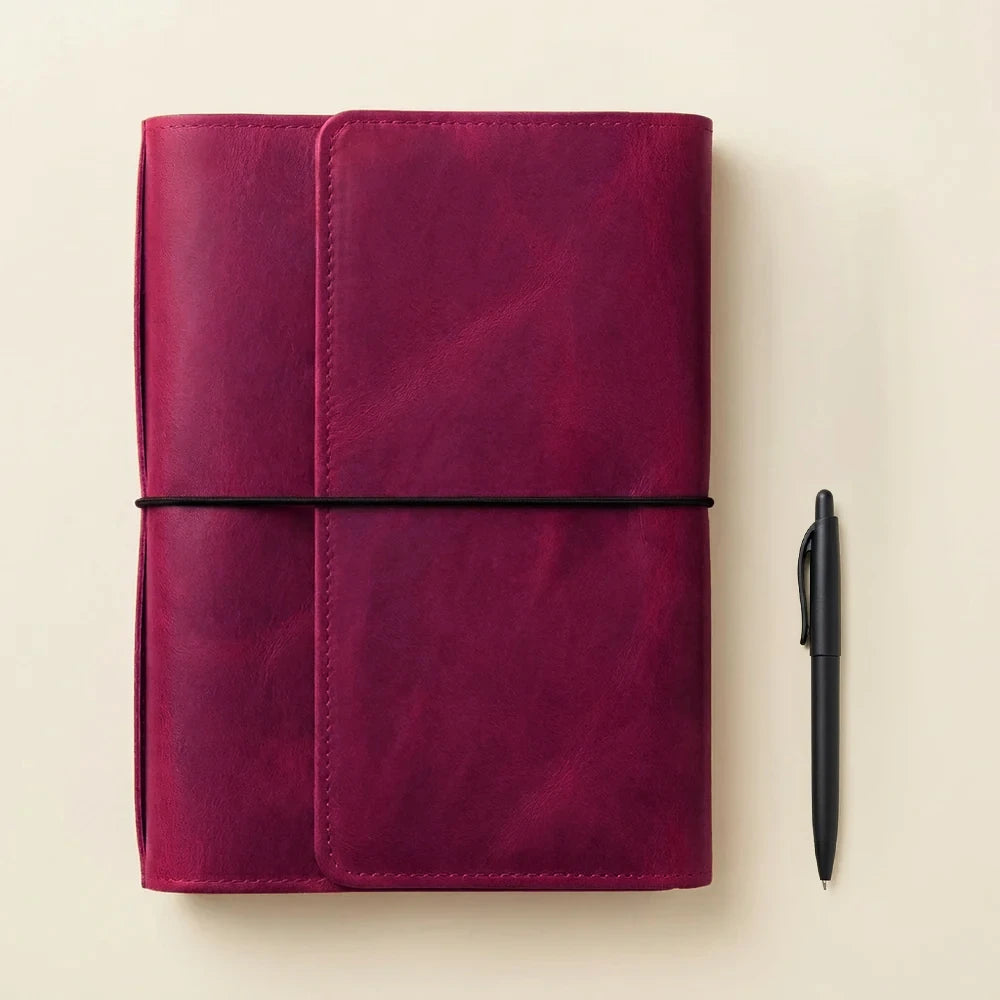 Leather notebook cover with six elastic bands for organizing journals, planners, and inserts.