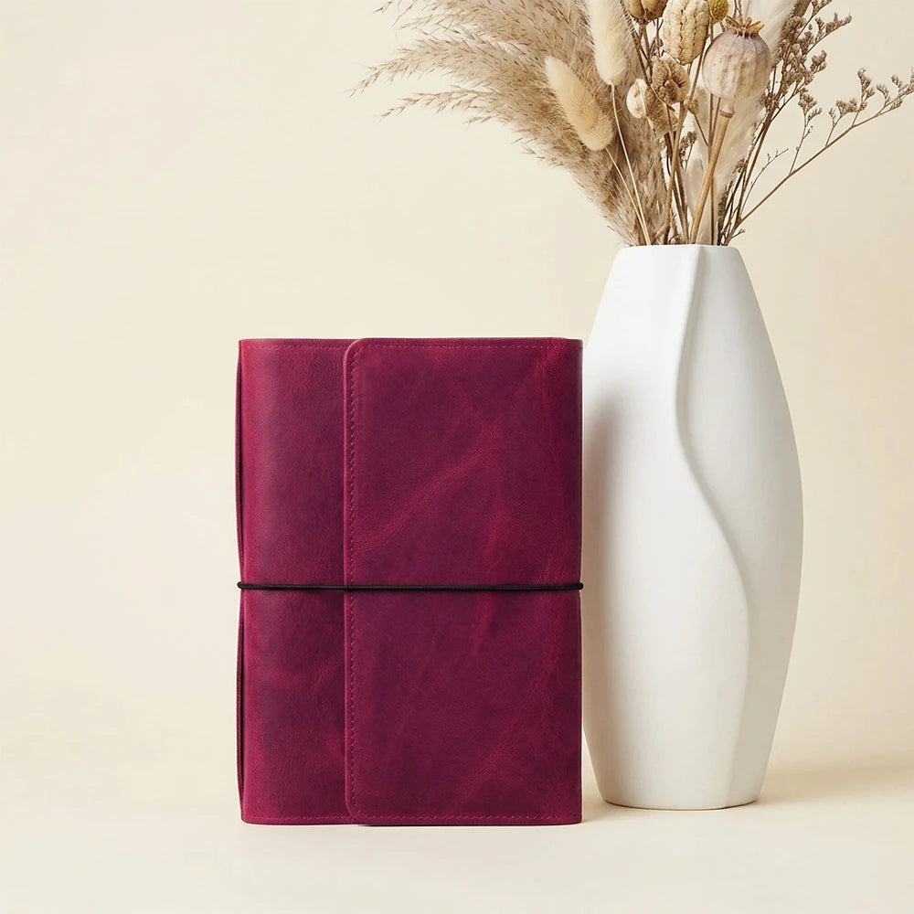 Handmade leather notebook cover with six elastic straps and spacious pockets inside.