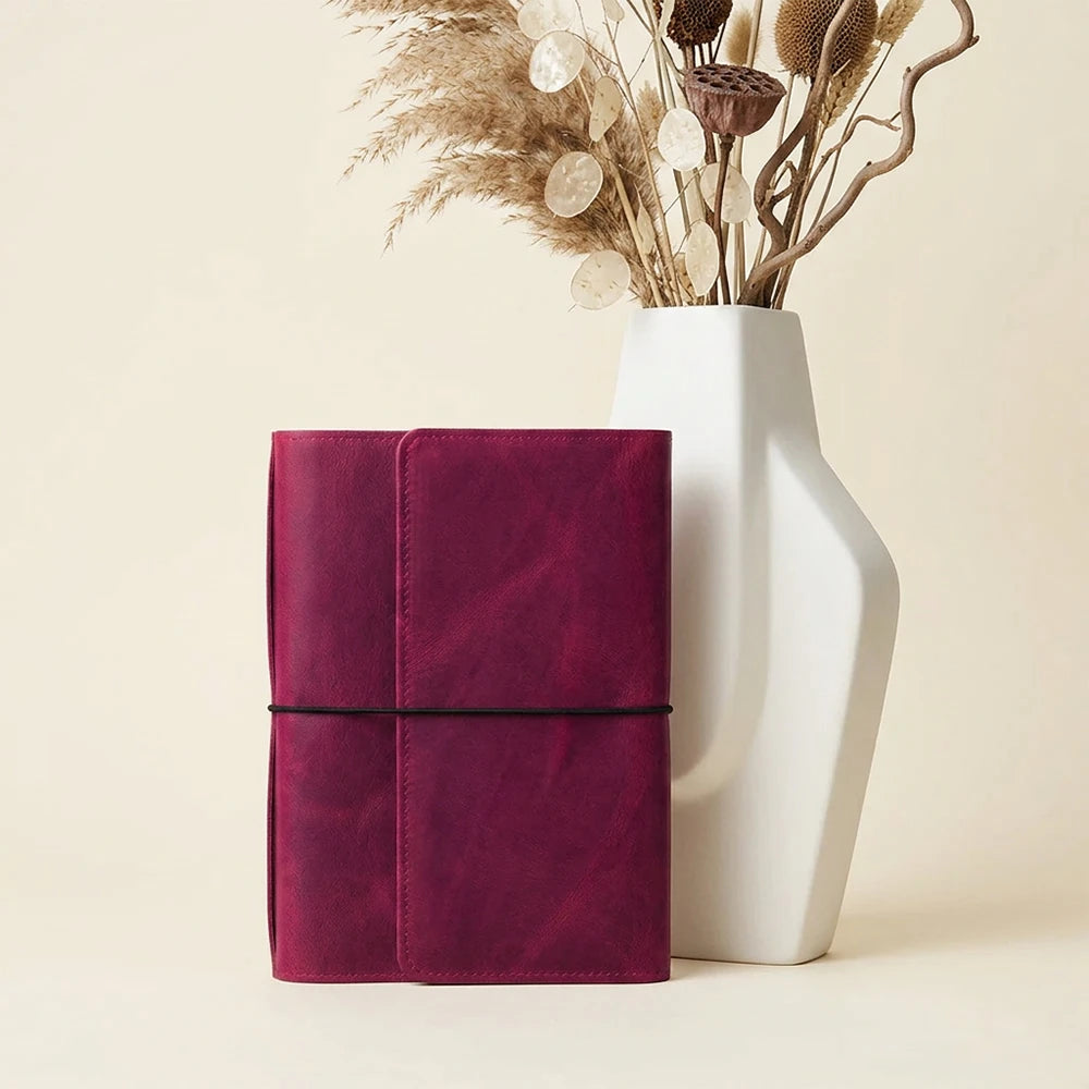 Natural leather journal cover featuring six elastic closures and multiple practical pockets.