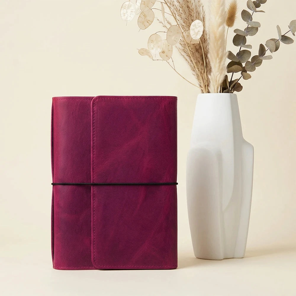 Handmade leather notebook cover featuring six elastic bands and functional inside pockets.