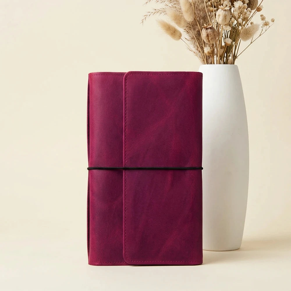 Handmade leather journal organizer with six elastic bands and practical storage compartments.
