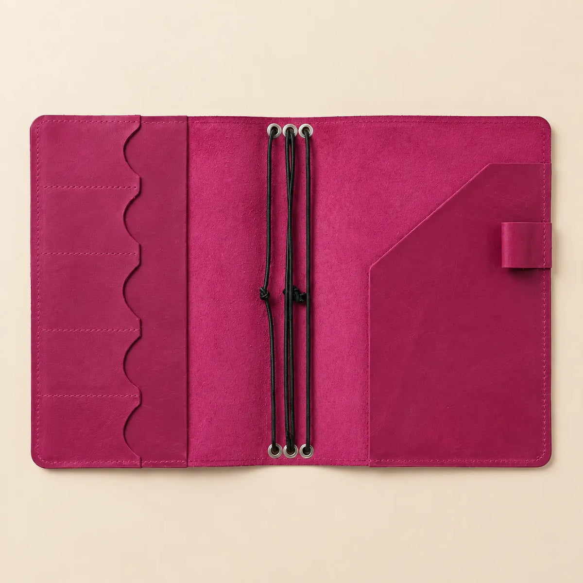 Square product photo highlighting a pink leather journal cover with organized interior pockets.