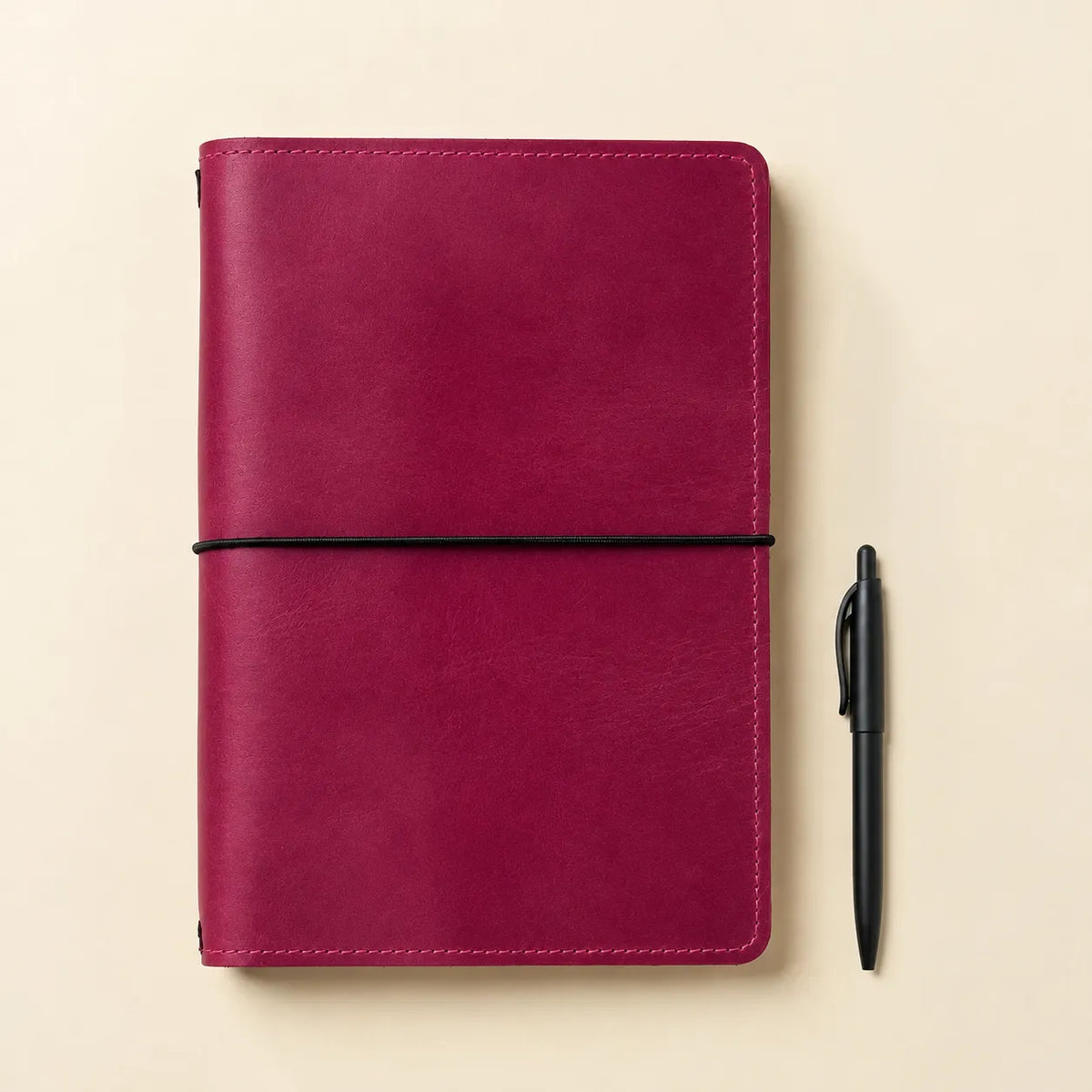 Square photograph of a pink genuine leather journal cover with useful inner compartments.