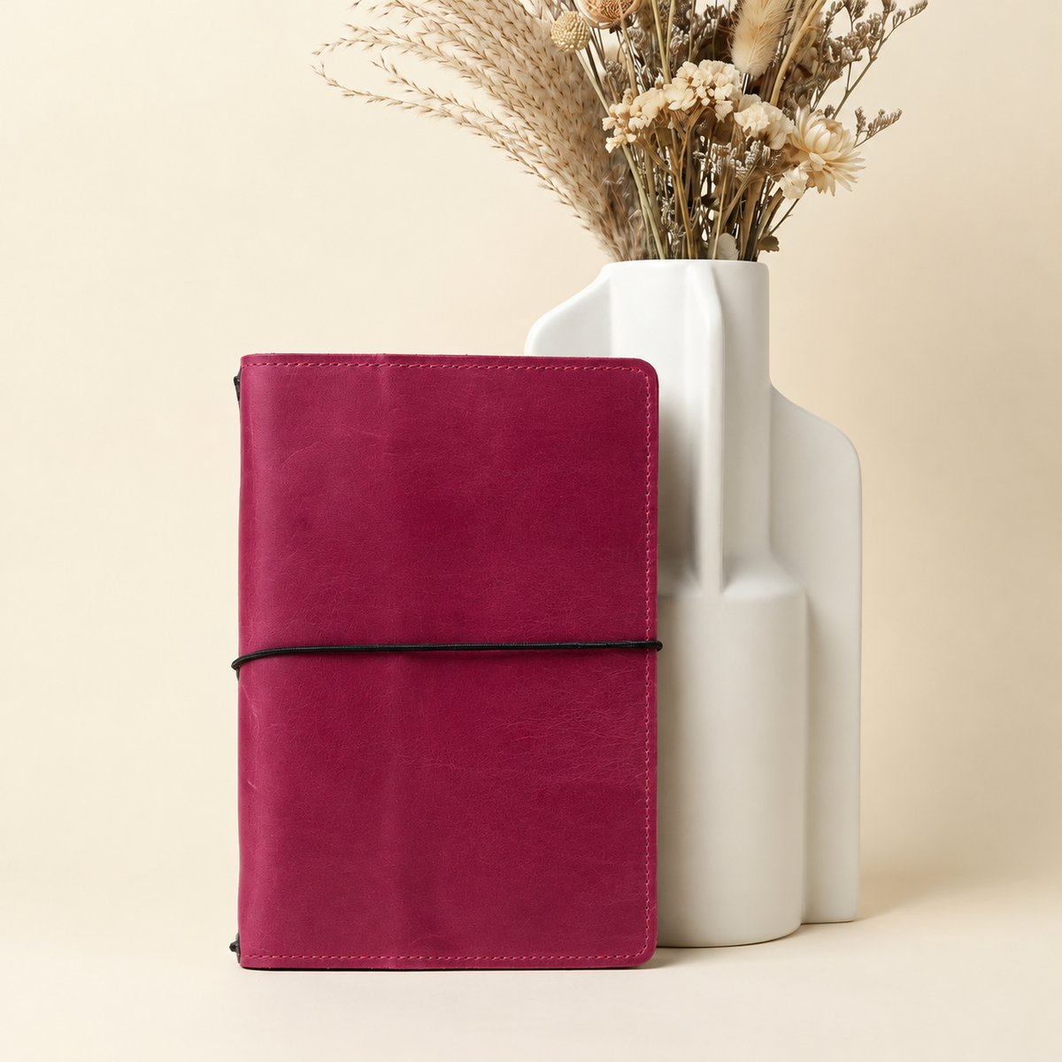 Pink natural leather notebook with a textured Crazy Horse finish and interior pockets, square image.