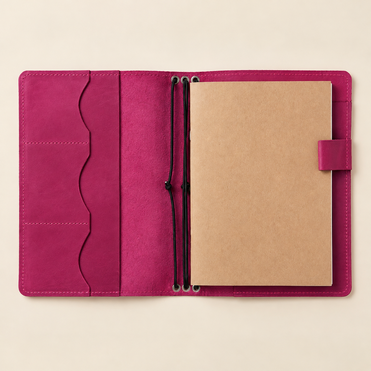 Square product photo of a pink leather notebook cover with built-in storage compartments.