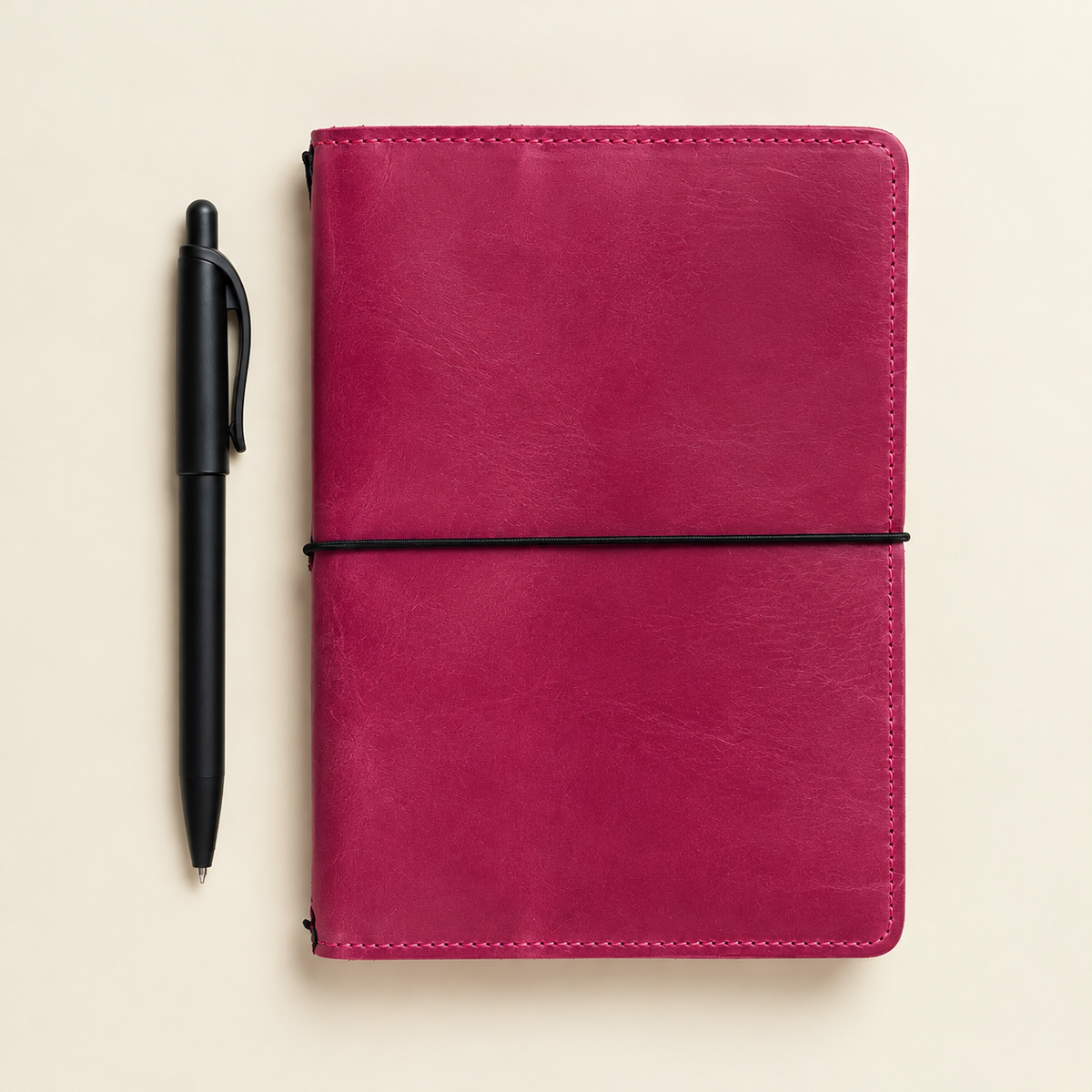 Square image of a pink first-grade leather notebook cover with practical inner pockets.