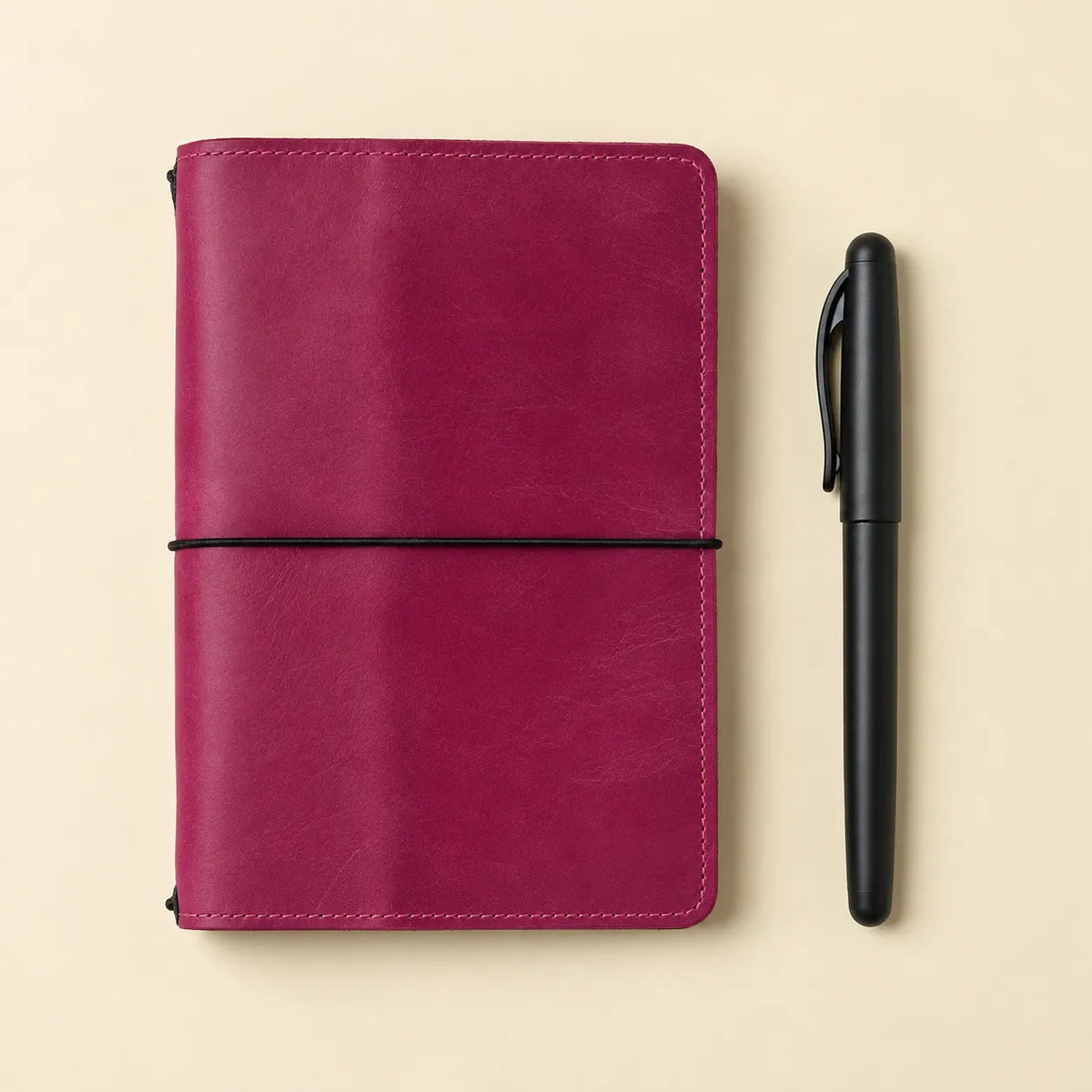 Square image showcasing a pink genuine leather notebook cover with functional interior pockets.