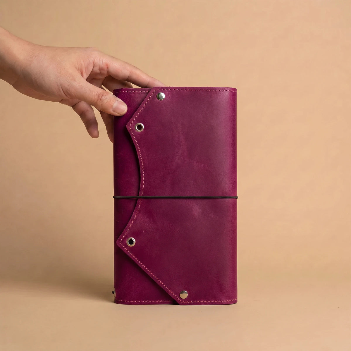 Refillable leather journal organizer with convenient zipper pocket inside for travel accessories.