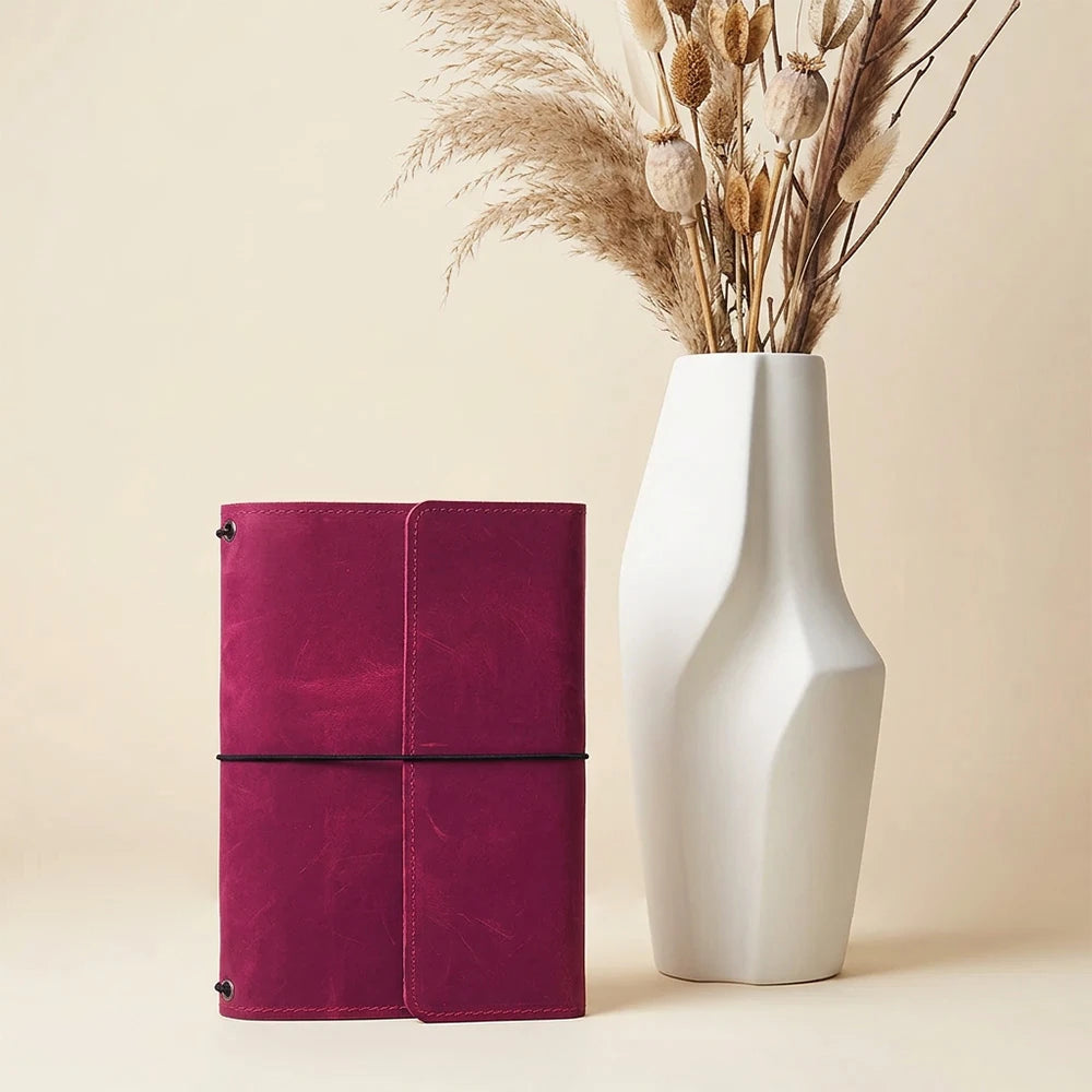 Handmade leather notebook cover featuring three elastic bands and multiple pockets