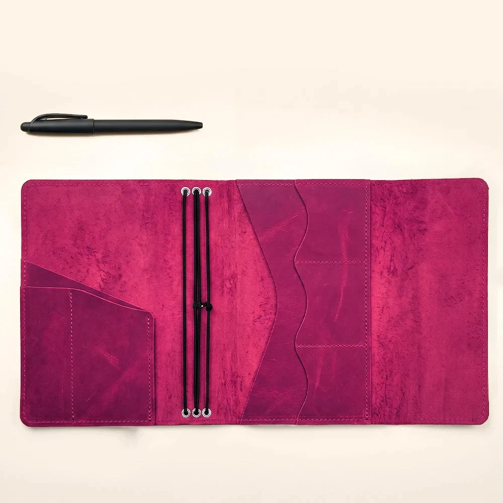 Leather notebook cover with three elastic bands and several interior storage pockets